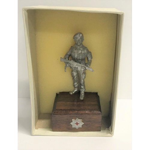 384 - Boxed military figure of a British Paratrooper in metal on wood plinth,

8cm tall