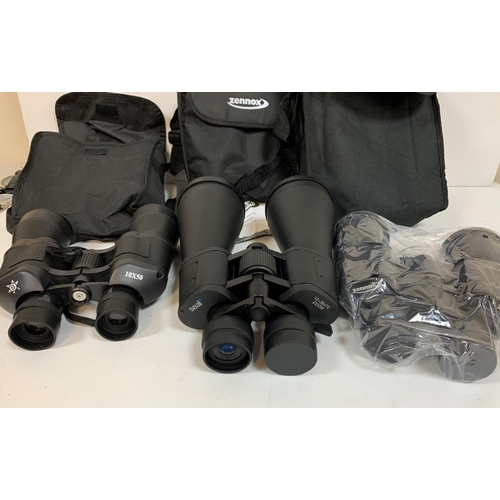 434 - Three sets of powerful, as new, binoculars with covers (3)