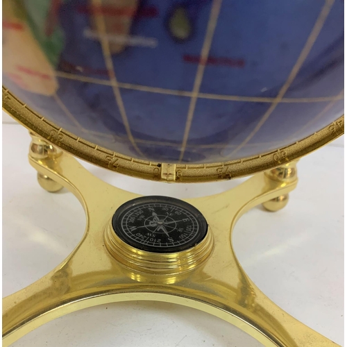 437 - Blue stone globe in brass setting with compass to base