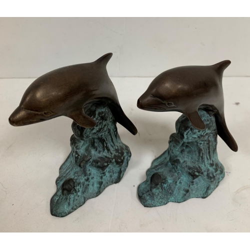 446 - Pair of unmarked bronze, leaping Dolphins (2),

17cm tall