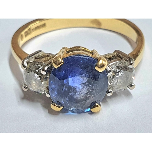 7 - 18ct yellow gold ring set with a central round cut Sapphire (approx 2.2cts) flanked to either side b... 