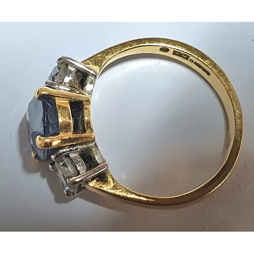 7 - 18ct yellow gold ring set with a central round cut Sapphire (approx 2.2cts) flanked to either side b... 