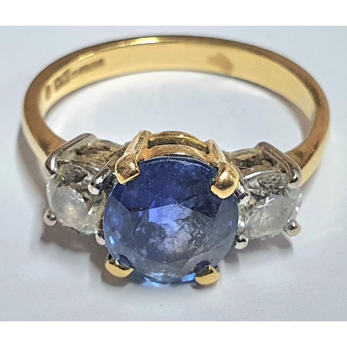 7 - 18ct yellow gold ring set with a central round cut Sapphire (approx 2.2cts) flanked to either side b... 