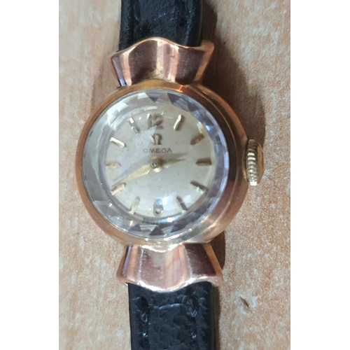 23 - Ladies vintage 9ct gold cased Omega watch with black leather strap