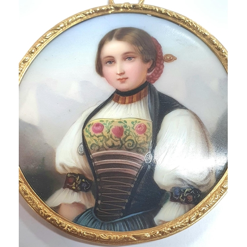 11 - Fine late 19thC unsigned circular miniature portrait of a young Swiss girl in traditional costume ho... 