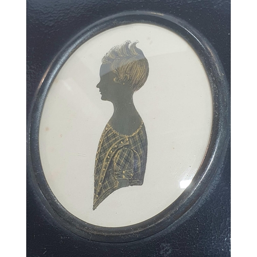 12 - Unsigned, early 19thC silhouette of a young girl, highlighted in gilt housed in its original ebonise... 