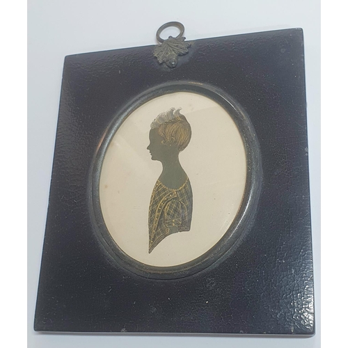 12 - Unsigned, early 19thC silhouette of a young girl, highlighted in gilt housed in its original ebonise... 