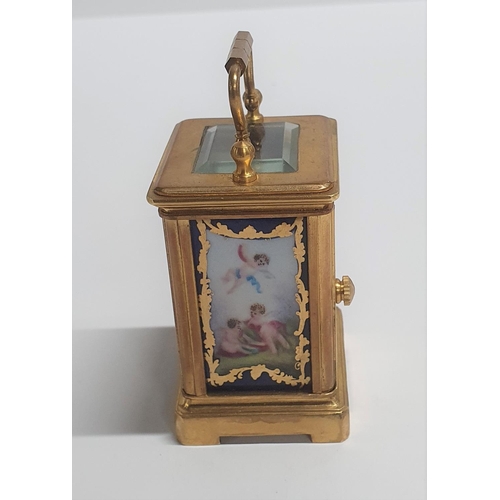 45 - Vintage French miniature carriage clock with porcelain panels and bevelled glass complete with trave... 