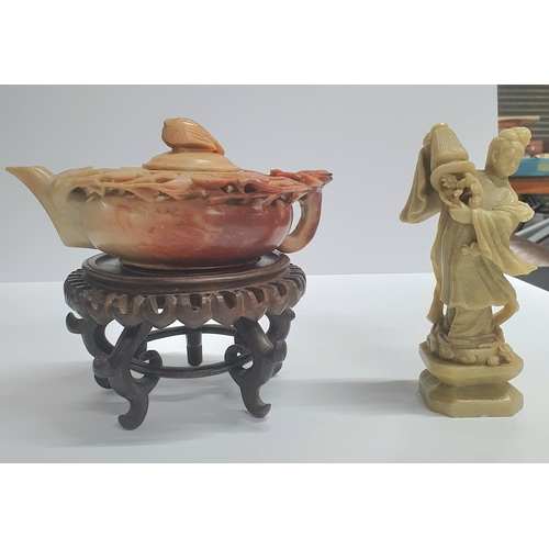 38 - Antique Oriental soapstone carved teapot on a hardwood stand together with another antique soapstone... 