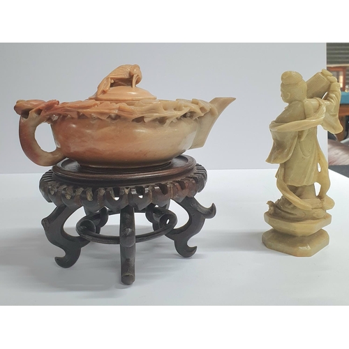 38 - Antique Oriental soapstone carved teapot on a hardwood stand together with another antique soapstone... 