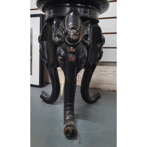 25 - Late Victorian, ebonised wooden carved planter stand in the form of 3 Elephant heads and trunks,

57... 