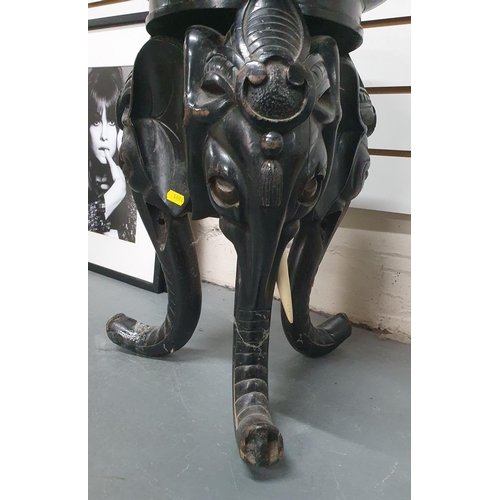 25 - Late Victorian, ebonised wooden carved planter stand in the form of 3 Elephant heads and trunks,

57... 