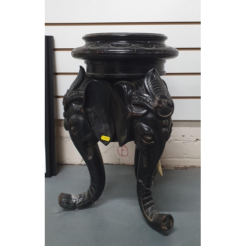 25 - Late Victorian, ebonised wooden carved planter stand in the form of 3 Elephant heads and trunks,

57... 