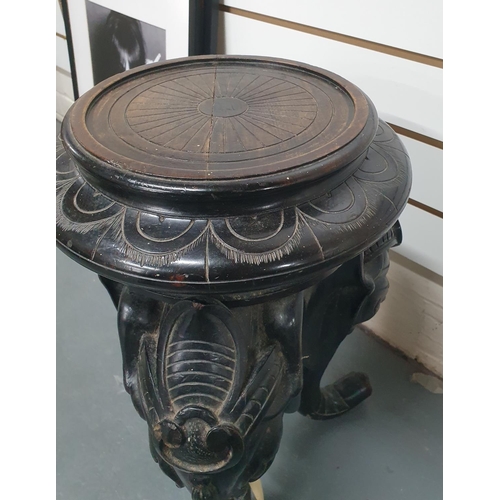 25 - Late Victorian, ebonised wooden carved planter stand in the form of 3 Elephant heads and trunks,

57... 