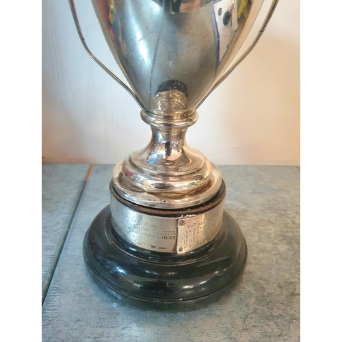 13 - Large 20thC silver trophy on wood plinth with silver winner banding,

The trophy weighs 660 grams, t... 