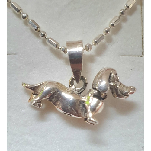 63 - Two silver necklaces with Sausage dog pendants together with a silver necklace with a silver Teddy B... 