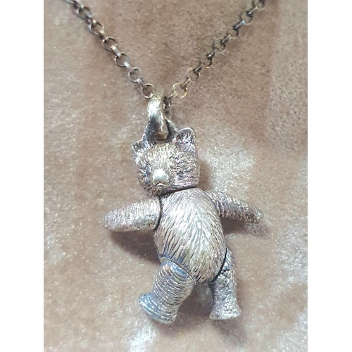 63 - Two silver necklaces with Sausage dog pendants together with a silver necklace with a silver Teddy B... 