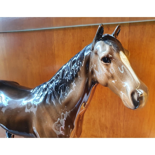 502 - Large Beswick glazed bay horse,

31cm high x 36cm long