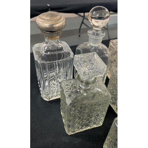 436 - 6 glass decanters, one with a white metal cap (6)