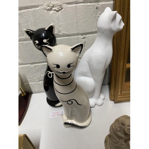 1058 - Two matching ceramic cat figures with one other