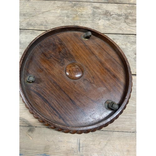 1163 - Old Mahogany circular vase stand on wheels