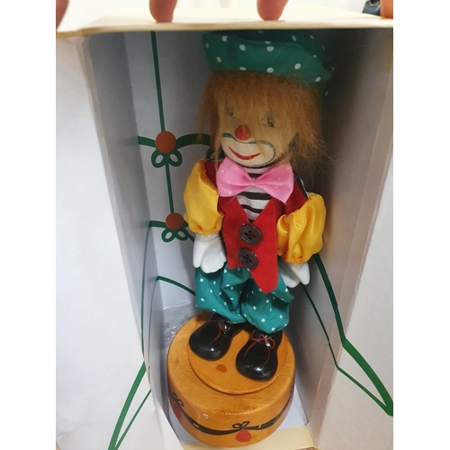 1235 - Boxed wooden clown on a stand