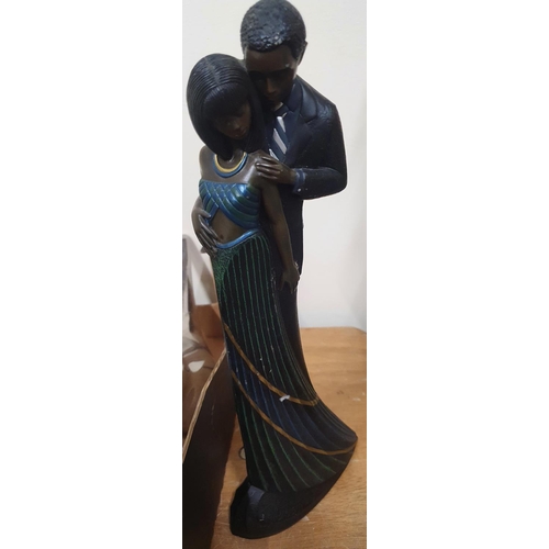 1240 - Tall, modern black man and lady figurine