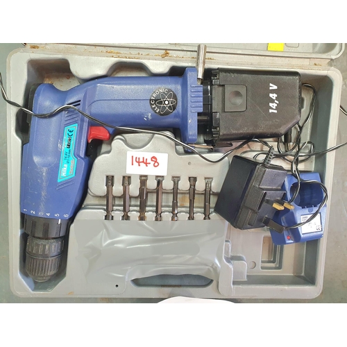 1448 - Hilka drill with both electric lead and battery and charger, drill bits and hard carry case