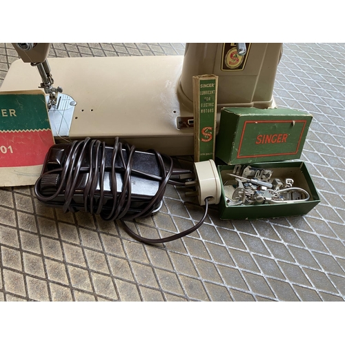 59 - Singer sewing machine with carry case and foot pedals