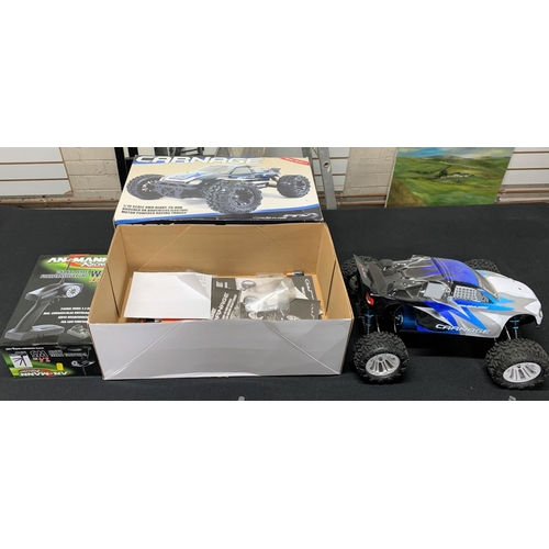 113 - Boxed, as new, large, remote controlled over-sized wheeled car together with a boxed remote control ... 