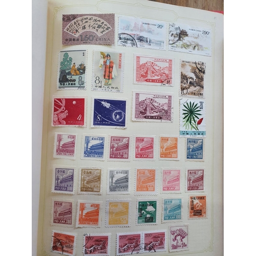 189 - Two red stamp albums to include QV Canada including a used 5d 1868 etc and a good quantity of China,... 