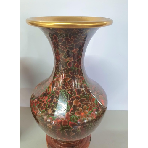 307 - Pair of brown Cloisonné vases on hardwood stands (2),

Both measure 24cm tall