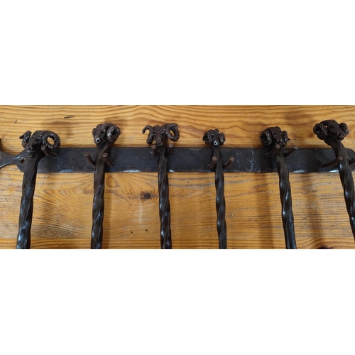 240 - Finely cast, iron fire poker set with unusual rams head tops