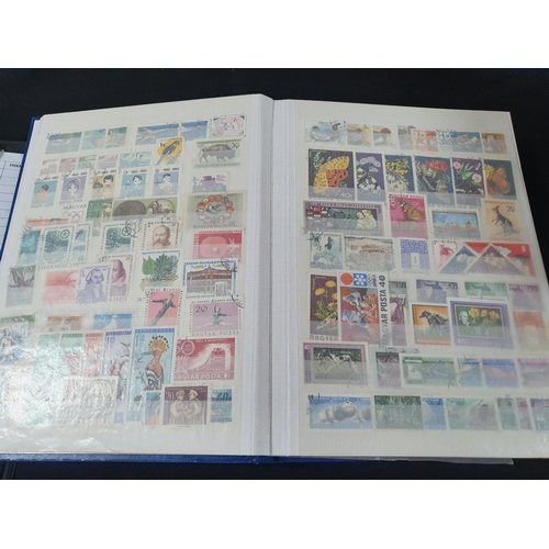 202 - Blue stamp album containing a large collection of used & mint stamps including 19thC India and Jamai... 