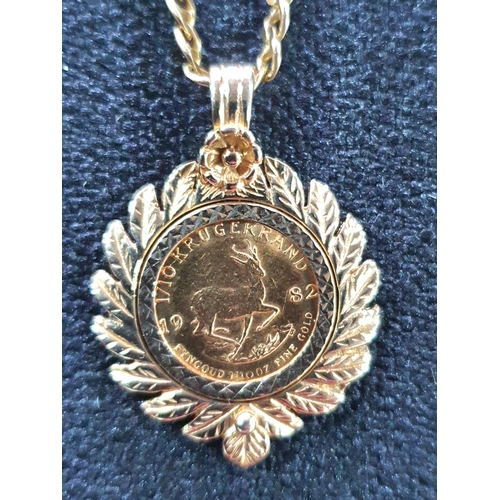 18 - 1982 1/10th oz Krugerand set in a hallmarked laurel wreath pendant on a 9ct gold flat linked chain s... 