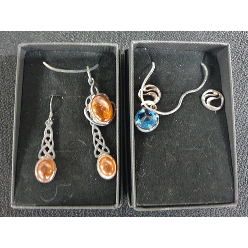 26 - Two silver necklace and pendants with associated earring sets (2)