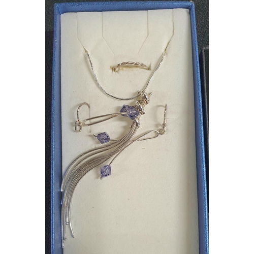 29 - Two silver necklaces with fancy Amethyst pendants together with associated earrings etc and both in ... 