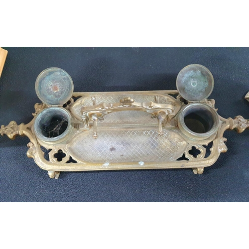 108 - Ornately cast antique brass inkwell and pen rest together with a raised table-top ornate vintage ash... 