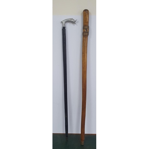 338 - Two antique silver topped walking canes together with a white metal topped walking cane & another (4... 