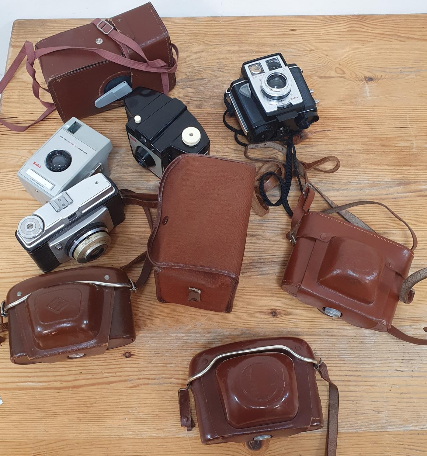 Eight vintage cameras including Kodak Brownie Vecta, Brownie