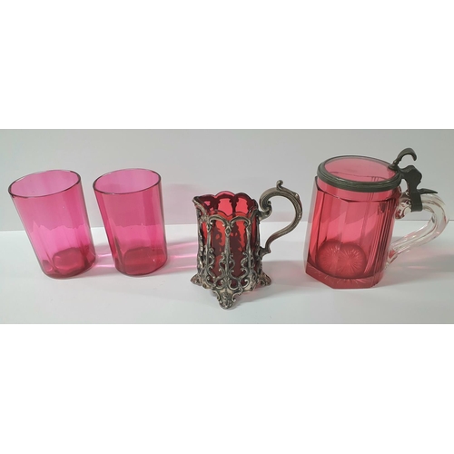 55 - Victorian cranberry tankard with pewter collar & handle together with a cranberry over-laid jug and ... 