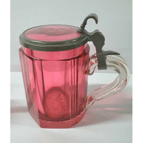55 - Victorian cranberry tankard with pewter collar & handle together with a cranberry over-laid jug and ... 