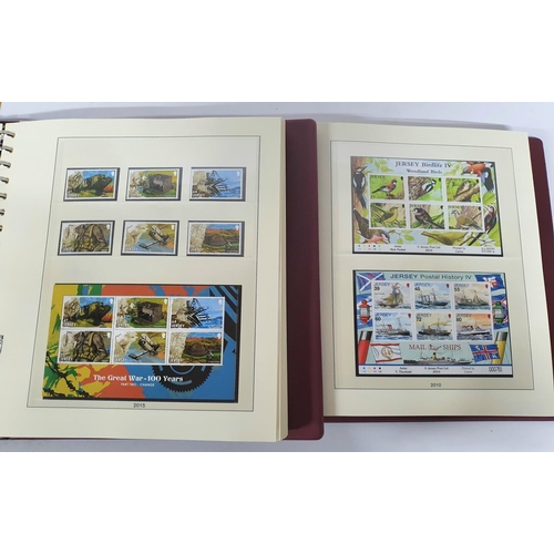 222 - Two red box albums both containing mint unmounted complete Jersey 2010 to 2018 - over £900 face valu... 