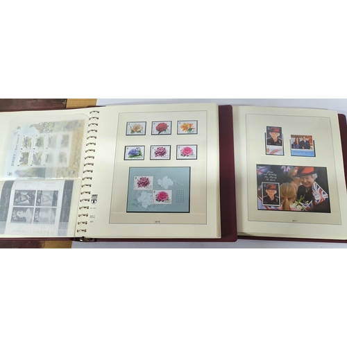 222 - Two red box albums both containing mint unmounted complete Jersey 2010 to 2018 - over £900 face valu... 