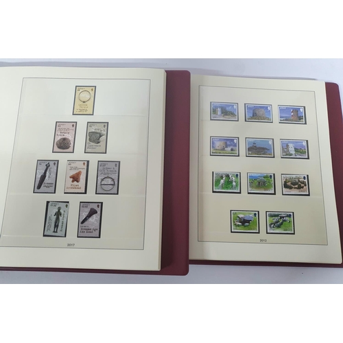 222 - Two red box albums both containing mint unmounted complete Jersey 2010 to 2018 - over £900 face valu... 