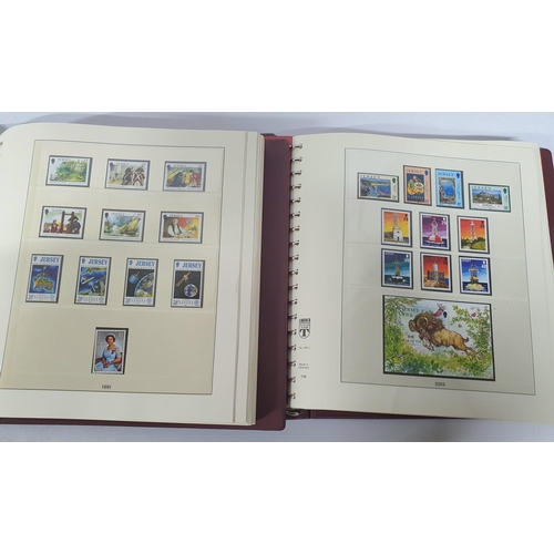 223 - Two red box albums both containing mint unmounted complete Jersey 1991 to 2009 - approx £675 face va... 