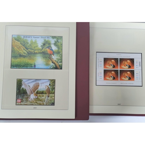 223 - Two red box albums both containing mint unmounted complete Jersey 1991 to 2009 - approx £675 face va... 