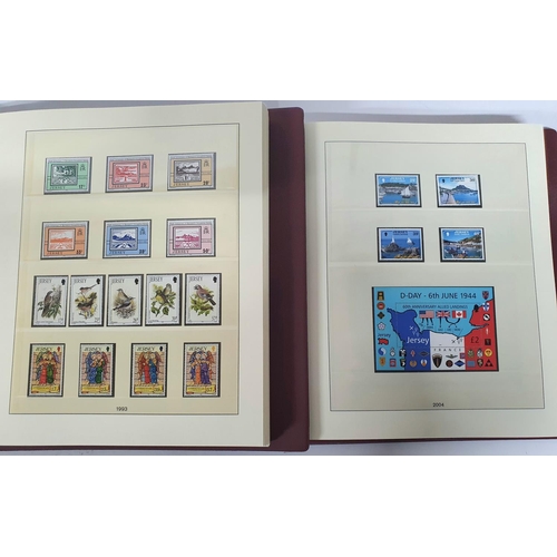 223 - Two red box albums both containing mint unmounted complete Jersey 1991 to 2009 - approx £675 face va... 