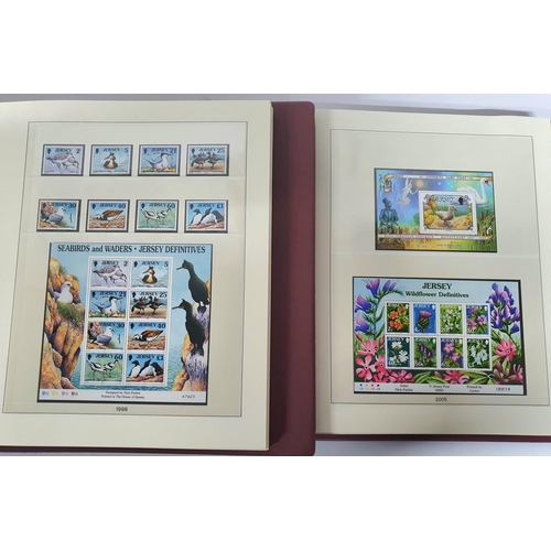 223 - Two red box albums both containing mint unmounted complete Jersey 1991 to 2009 - approx £675 face va... 