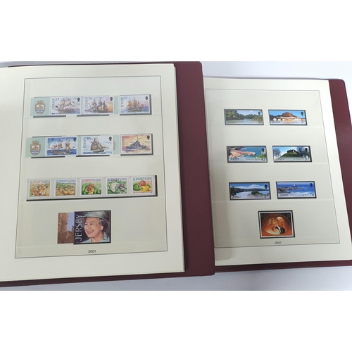 223 - Two red box albums both containing mint unmounted complete Jersey 1991 to 2009 - approx £675 face va... 